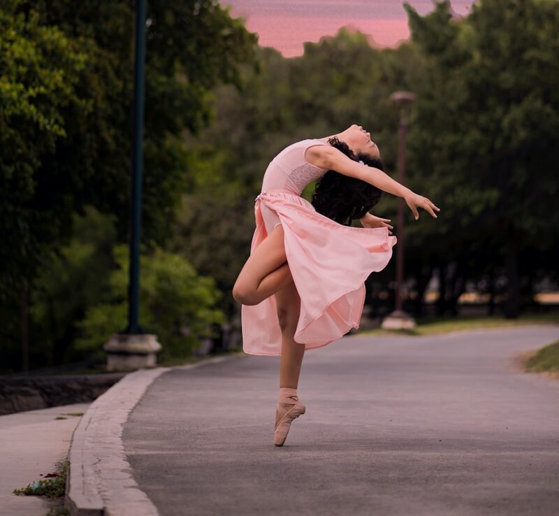 ballet dancer on road beside street lamp